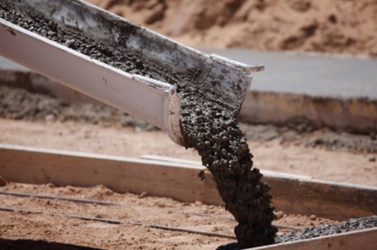 Fresh concrete being poured from a chute