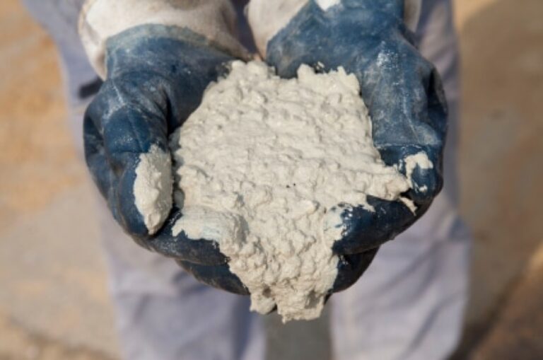 Gloved hand holding cement mix